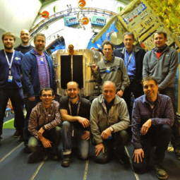 A happy FIFI-LS team in front of their instrument mounted on SOFIA’s telescope instrument flange
