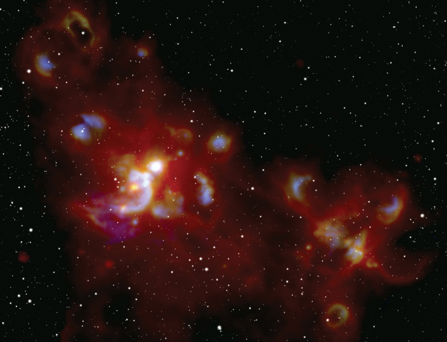 A cosmic light show sparked by the formation of massive stars in the W51 stellar nursery